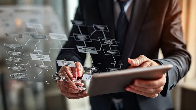 A photorealistic, professional photography shot of a business executive meticulously mapping out a complex flow chart with multiple interconnected nodes, representing various state tax jurisdictions and business operations. The executive is focused, with a tablet displaying data. Cinematic lighting, sharp focus, depth of field, 8K hyper-detailed, shot on a high-end DSLR.
