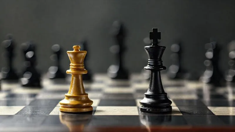 A photorealistic, professional photography, 8K, cinematic lighting. A chessboard with a few pieces, one piece representing a VC, another a startup, surrounded by risk factors symbolized by blurry, dark figures in the background. Sharp focus on the central pieces, depth of field. Shot on a high-end DSLR.